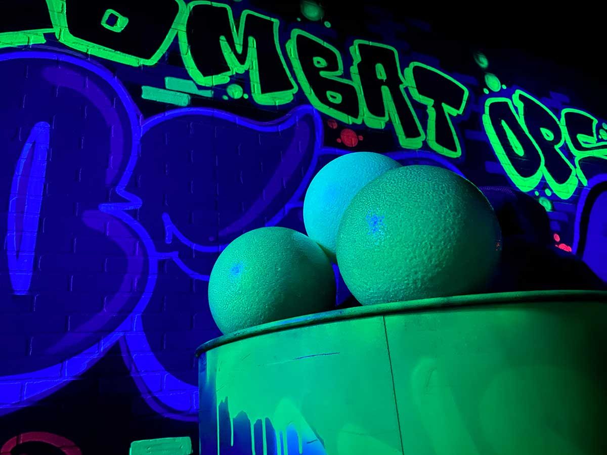 Foam dodgeballs in front of the painted Combat Ops wall