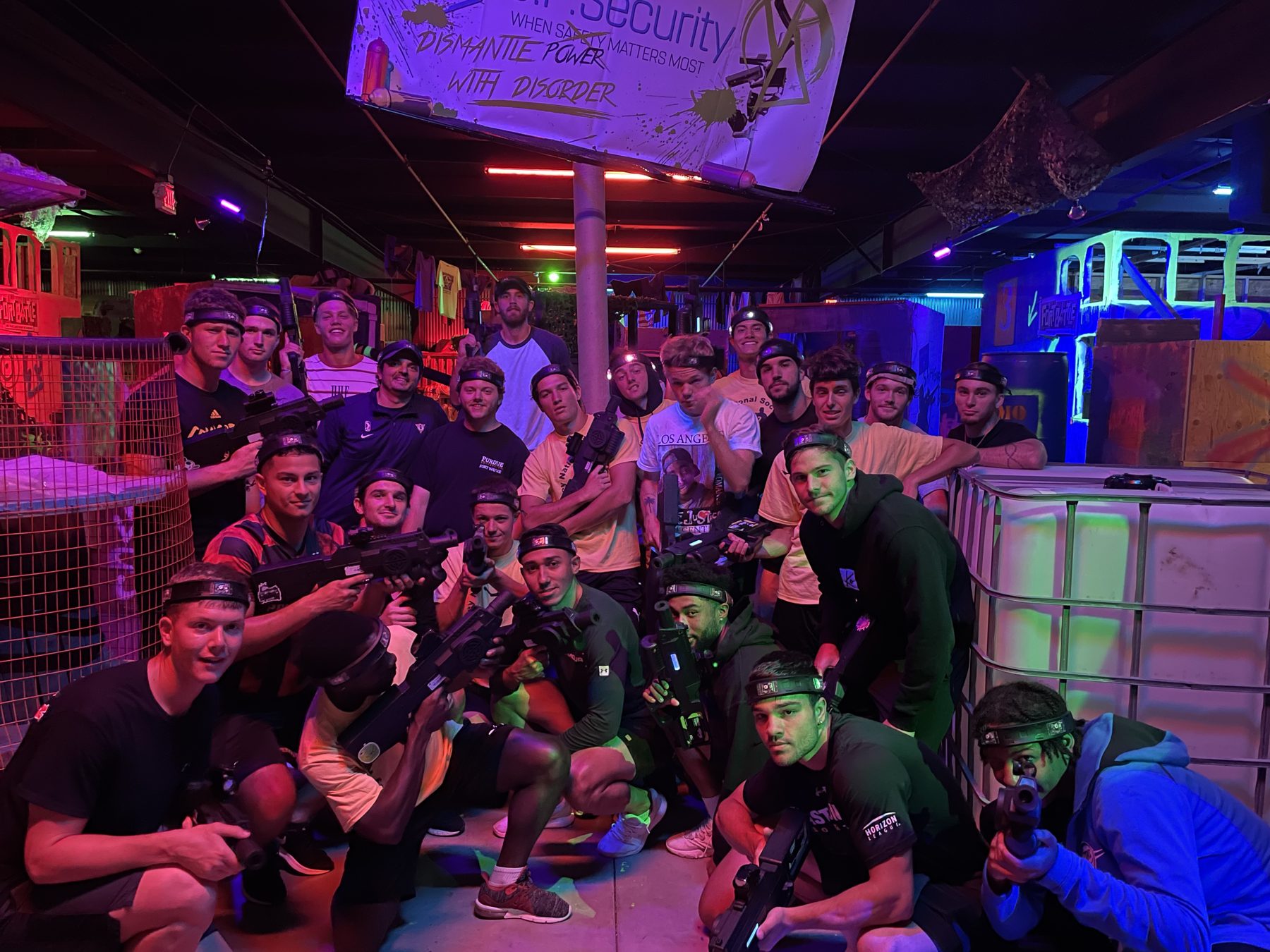 A large group in laser tag gear inside the Combat Ops arena